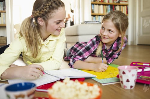 Preview: Two Young Girls Coloring And Doing Homework Together