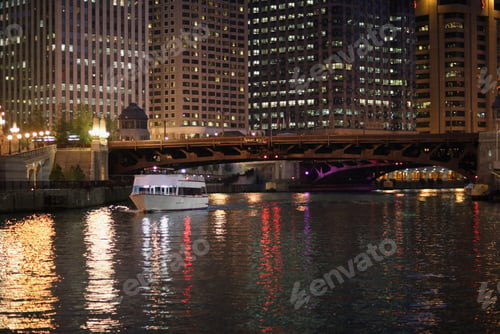 Preview: Eastern View Of Chicago River And The Michigan Avenue Bridge With Commuter Boat At Night, Chicago