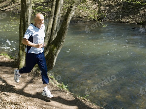 Preview: Senior Man Running On Nature Trail
