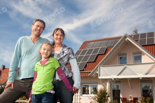 Preview: Happy Family Standing In Front Of House With Solar Panels