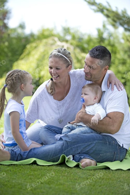Preview: Family With Baby Boy Sitting Together In Park