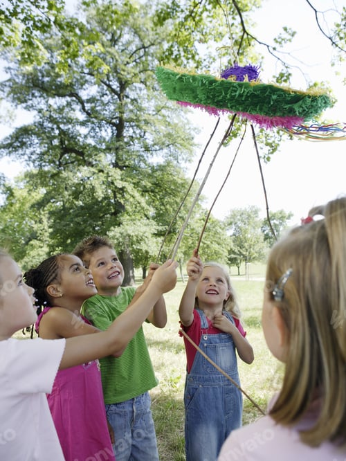 Preview: Group Of Young Children Playing With Pinata Outdoors
