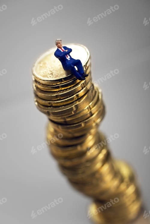 Preview: Stack Of Euro Coins With Businessman Figurine