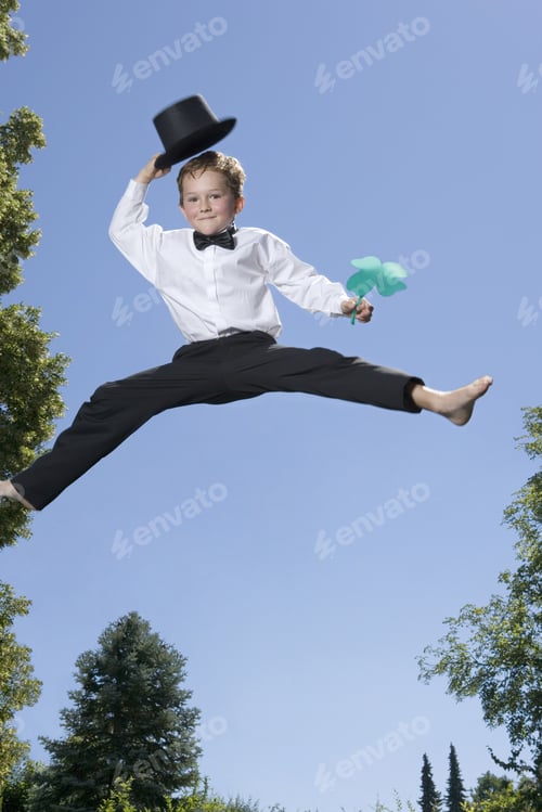Preview: Young Boy With Four Leaf Clover Jumping In Air