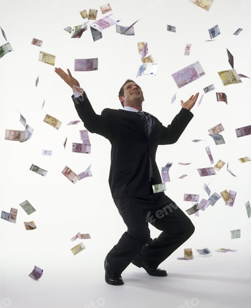 Preview: Studio Shot Of Money Falling On Businessman