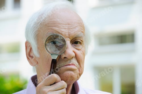 Preview: Senior Man Looking Through Magnifying Glass