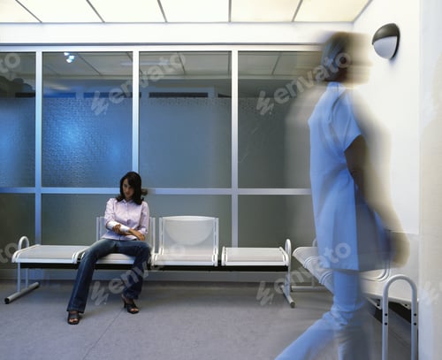 Preview: Woman In Hospital Waiting Room, Health Care Worker Walking Past