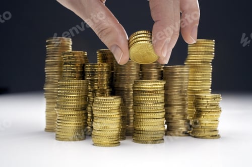 Preview: Stack of Coins and Human Hand Holding Coins