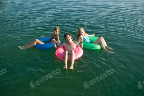 Preview: Teenagers In Inner Tubes On Lake