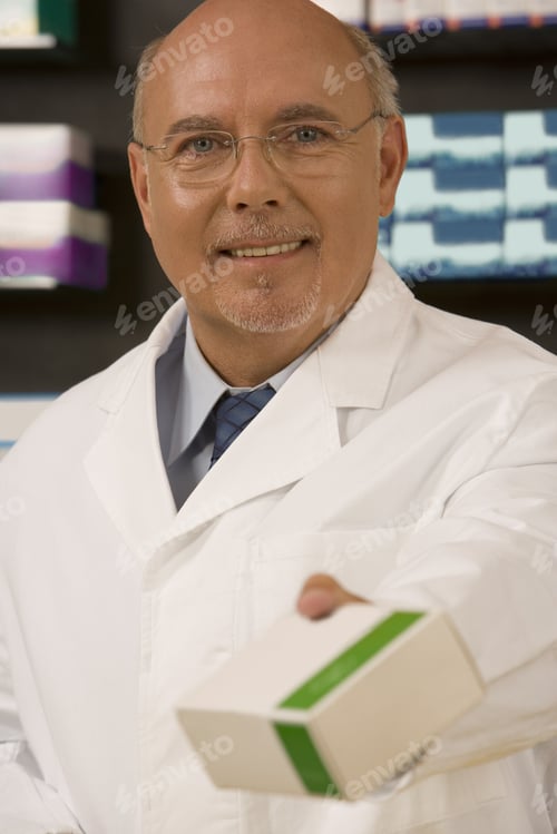 Preview: Male Pharmacist Smiling And Holding Medication