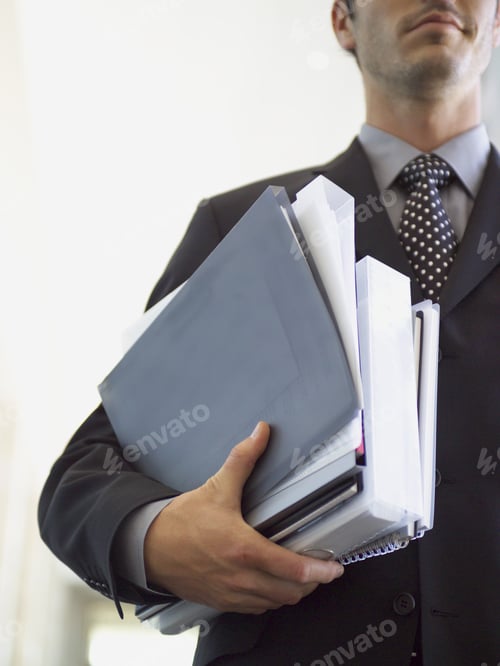 Preview: Low Angle View Of Businessman Carrying Paperwork