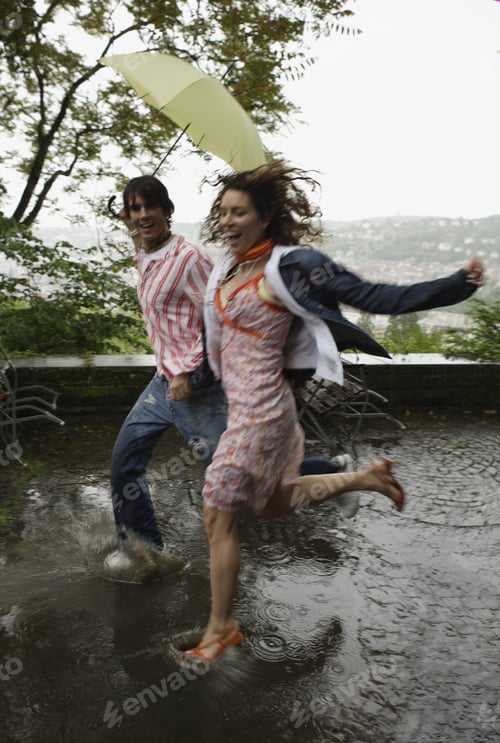 Preview: Couple Running Through Puddle In Rain