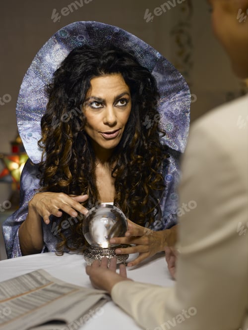 Preview: Female Fortune Teller With Crystal Ball Talking To Client