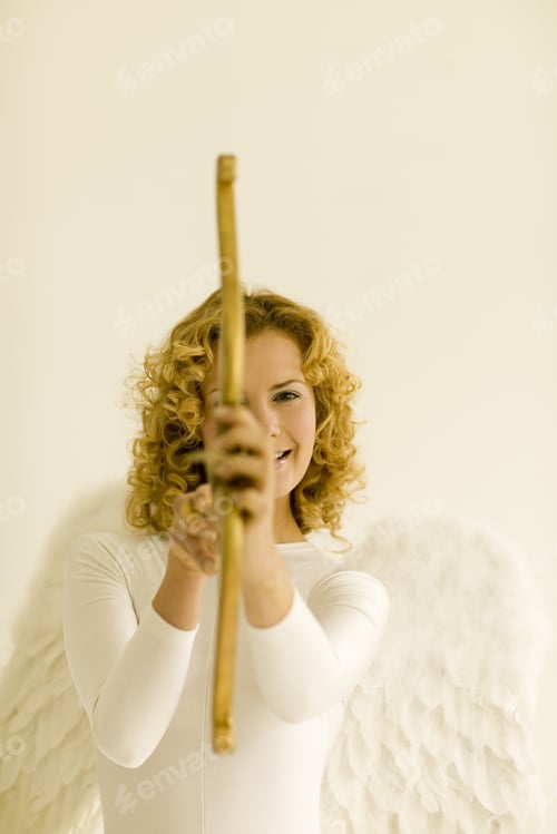 Preview: Woman Wearing Angel Wings And Aiming Cupid’S Bow And Arrow