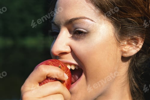 Preview: Young Woman Biting Into An Apple