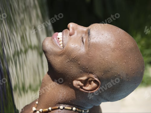 Preview: African Man With Face Up To Sunlight Smiling