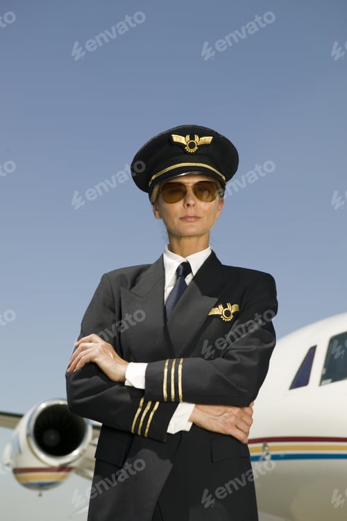 Preview: Female Pilot With Arms Crossed In Front Of Airplane