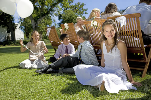 Preview: A Group Of Young Children Sitting On The Grass At A Wedding Reception