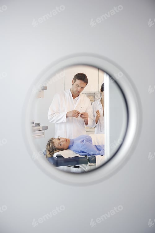 Preview: Male Doctor Examining Woman Laying On Table