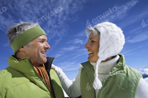 Preview: Senior Couple Wearing Winter Clothing And Smiling At Each Other Outdoors