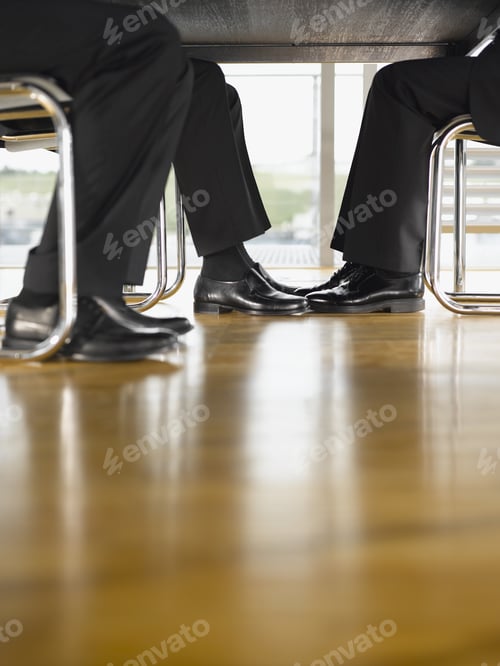 Preview: Close Up Of Businesspeople�S Feet Under Table