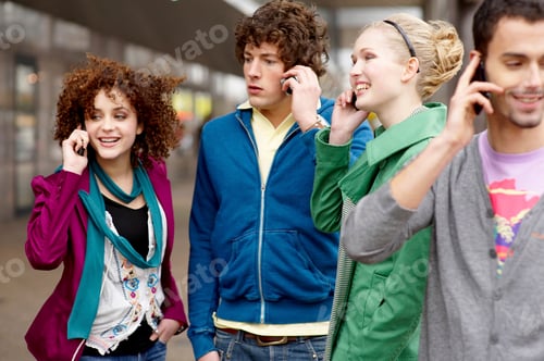 Preview: Four Teenage Friends In A Street Talking On Their Mobile Phones