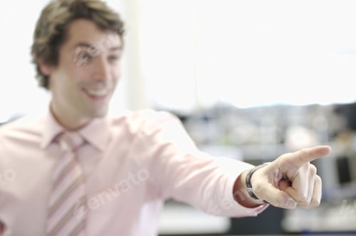 Preview: Businessman Smiling And Pointing Indoors