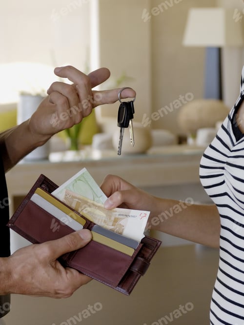 Preview: Detail Of Father Giving Daughter Car Keys And Money