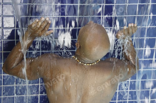 Preview: African Man Standing In Falling Water