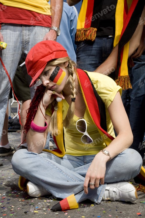 Preview: Sad Female Sports Fan Sitting On Ground