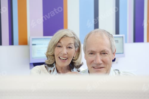 Preview: Senior Couple Using Computer At An Internet Cafe