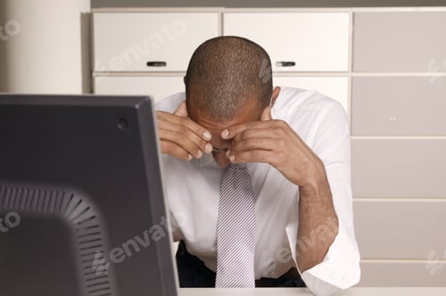 Preview: View Of Businessman With His Head In His Hands