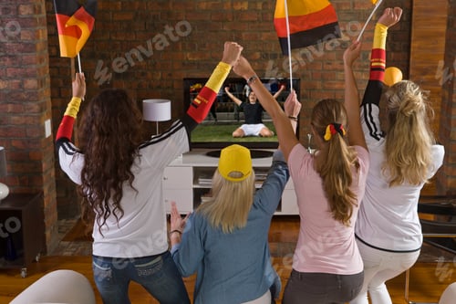 Preview: Young Women Cheering And Watching Women'S Soccer Game On Tv