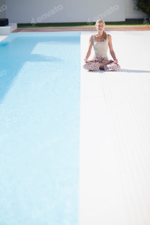 Preview: Mature Woman In Yoga Pose At Poolside Of Outdoor Pool
