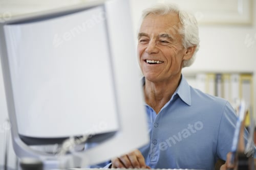 Preview: Man Smiling While Looking At Computer