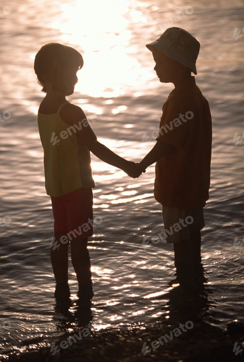 Preview: Silhouette Of Children Holding Hands At The Beach