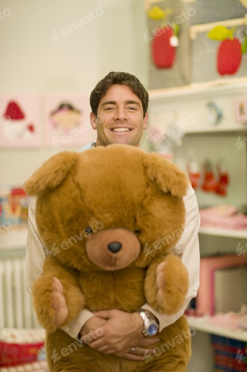 Preview: Man Smiling And Holding Large Teddy Bear
