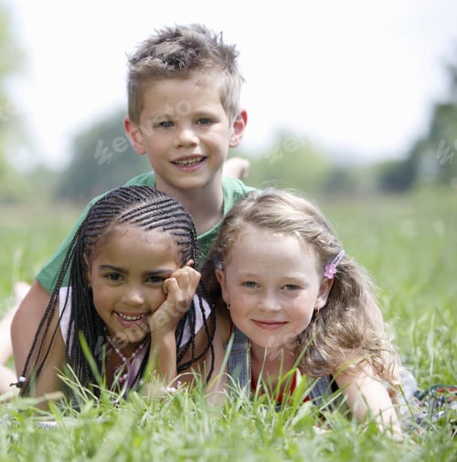 Preview: Two Girls And Boy Laying In Grass