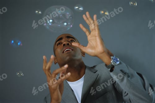 Preview: View Of Businessman Catching Bubbles