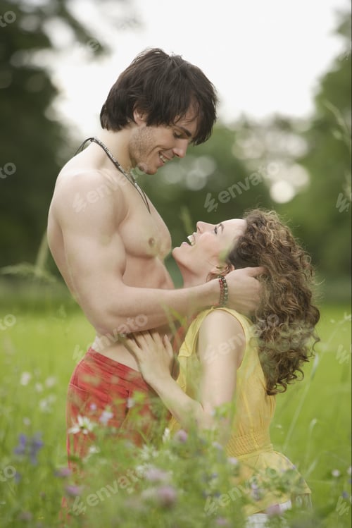 Preview: Couple Hugging And Smiling At Each Other In Meadow