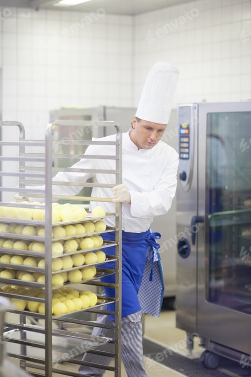 Preview: Chef With Tray Of Food In Kitchen