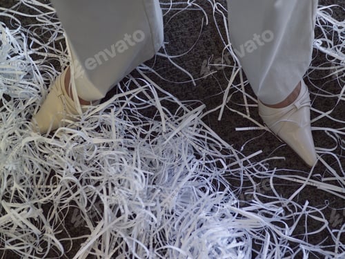 Preview: High Angle View Of Shredded Paper At Businesswoman’S Feet