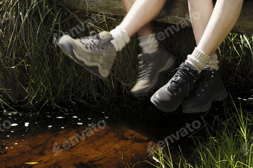 Preview: Couple'S Legs Dangling Over Stream