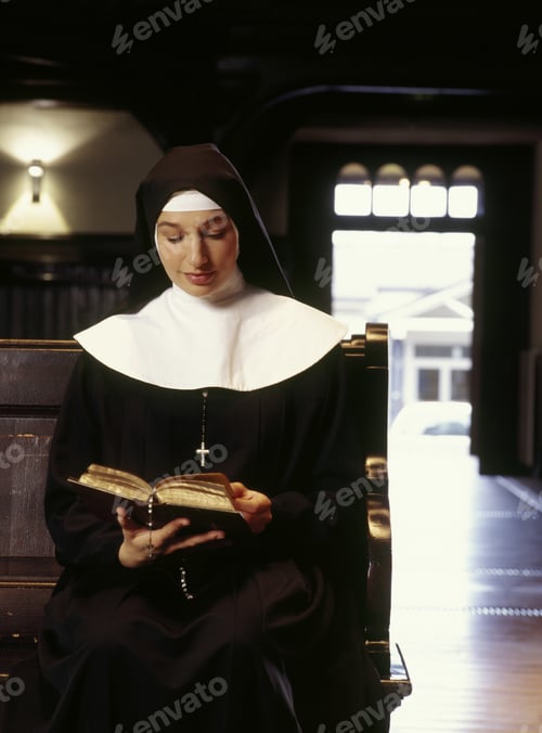 Preview: Young Nun Reading Bible In Church