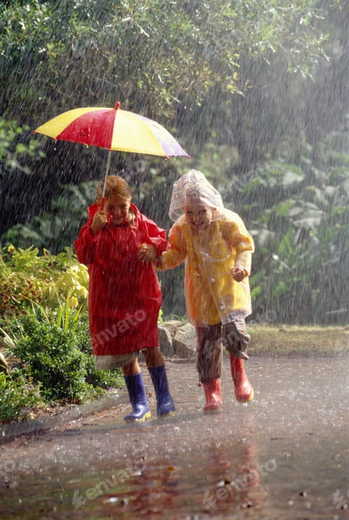 Preview: Children In Raincoats Sharing Umbrella