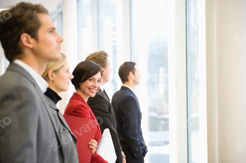 Preview: Businesspeople Standing Near Window In Office
