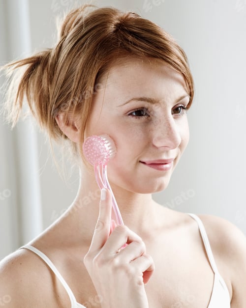 Preview: Portrait Of Young Redheaded Woman With Brush On Face, Studio Shot