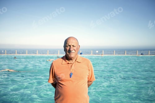 Preview: Portrait Of An Older Man Standing In Front Of A Pool Against Blue Sky