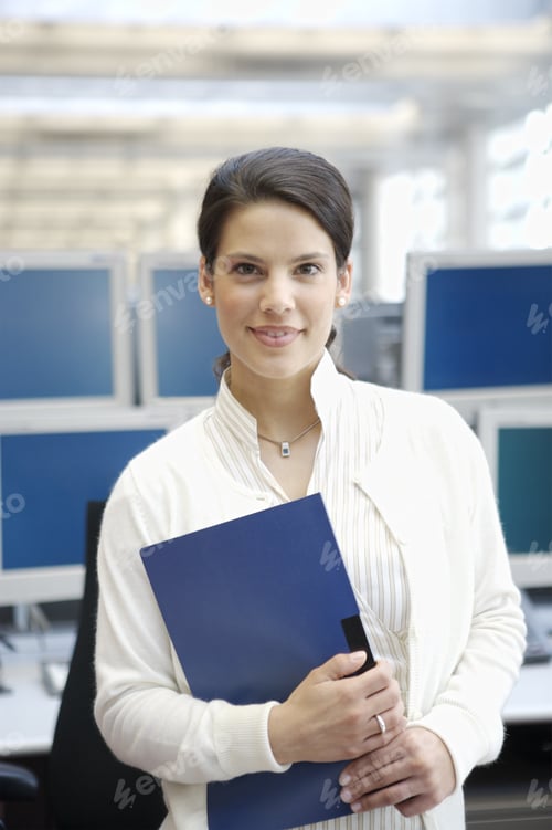 Preview: Businesswoman Smiling And Holding Binder In Office