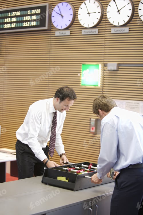 Preview: Two Businessmen Playing Foosball In Office